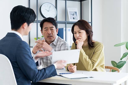 Malaysian couple reviewing income tax and retirement planning with a financial adviser