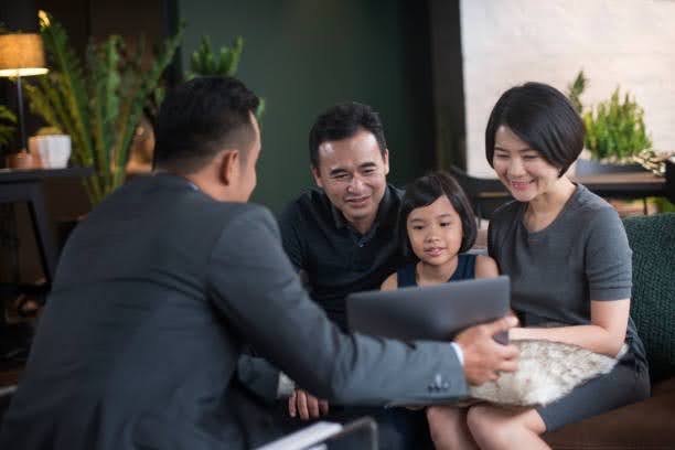Malaysian family discussing estate planning and transferring wealth to the next generation