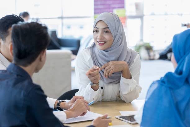 Malaysian business owner reviewing insurance and takaful as part of asset